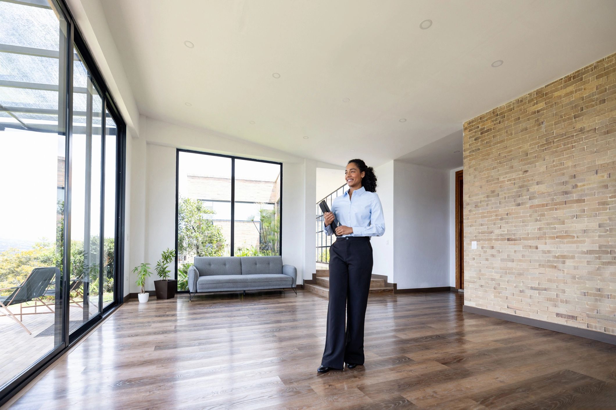 Real estate professional smiling in a property interior